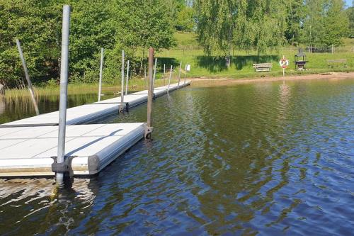 a dock in the middle of a body of water at Stort hus i vackra Karl Gustav, när fin bad och fiskesjö och Ullared in Karl Gustav