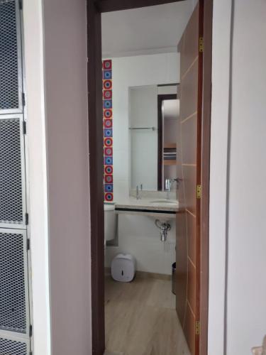 a bathroom with a sink and a mirror at Studio Bangalô Belém Hospedagem in Belém