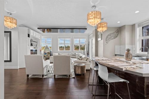 a kitchen and dining room with a long table and chairs at ELEMENT ON FIRST by Manna in Calgary