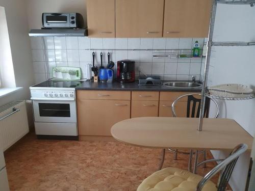 a small kitchen with a table and a stove at Apartment in Saxony in a charming area in Freital