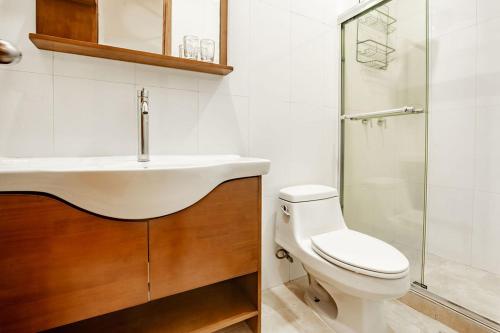 a bathroom with a sink and a toilet and a shower at Playa Venao Hotel Resort in Playa Venao