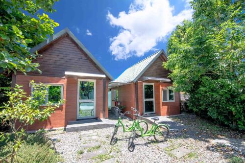 a house with two bikes parked in front of it at 田心民宿 in Dongshan