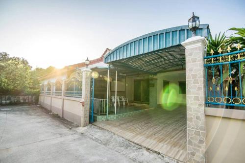 a building with a porch with a fence at Vanilla house heart of Sattahip in Sattahip