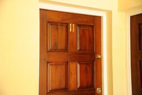 a wooden door in the corner of a room at GK Luxury Apartment in Kingston