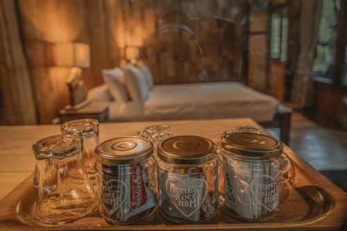 a tray with five cans of soda on a table at Gumi Ayu EcoStay in Munduk