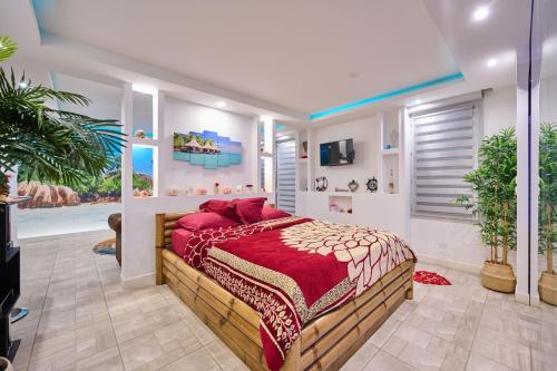 a bedroom with a large bed with red pillows at Sablotin SPA in Toulouse