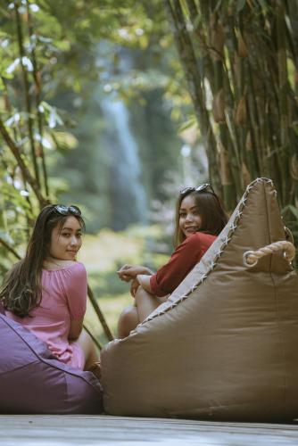 two young girls sitting on an inflatable at Gumi Ayu EcoStay in Munduk