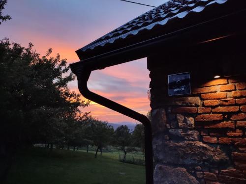 a view of a sunset from the outside of a building at Holiday Home "Sleme" with jacuzzi, big garden and arbor with fireplace in Skrad