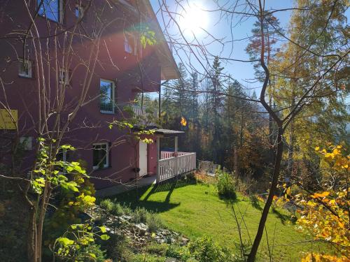a purple house with a yard in front of it at Apartamenty Lavender Hill in Wisła