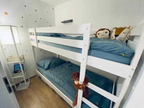 a bedroom with two bunk beds with blue sheets at cozy3 am Europa Park in Ettenheim