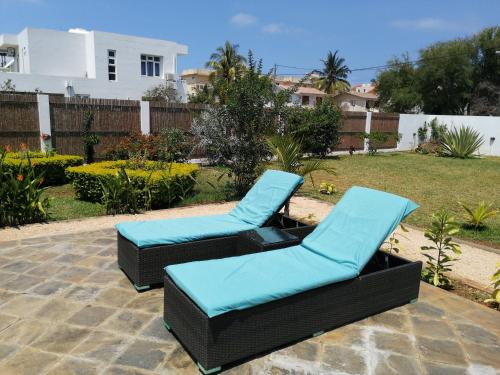 two chairs with blue cushions sitting on a patio at Villa Kayana in Flic-en-Flac