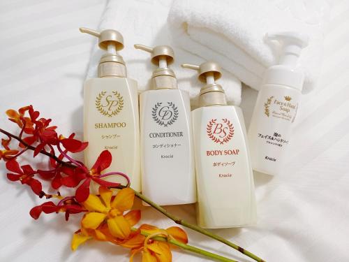 a group of three bottles of soap and flowers at Akasaka Urban Hotel in Tokyo
