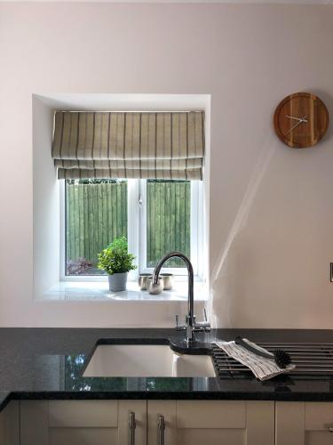 a kitchen with a sink and a window at The Manor Barn in Northampton