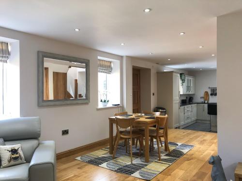 a kitchen and dining room with a table and chairs at The Manor Barn in Northampton
