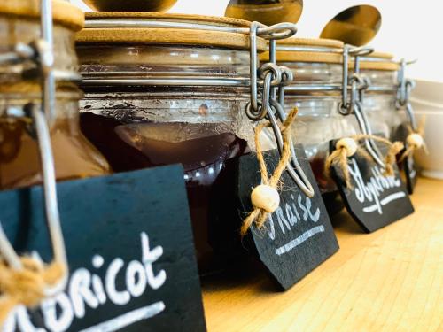 a group of jars of honey with tags on them at Hotel Le Midi Clermont-Cournon in Cournon-dʼAuvergne