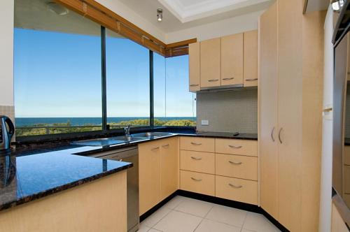 a kitchen with a large window with a view at Santorini Twin Waters in Mudjimba