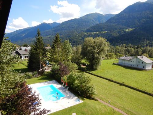 an aerial view of a backyard with a swimming pool and mountains at Ferienwohnungen Forellenhof Waldner in Gundersheim