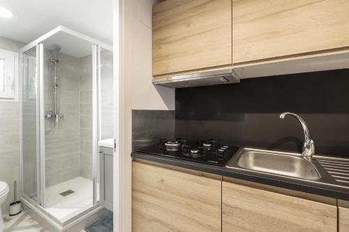 a kitchen with a sink and a shower at NEW Renovated COZY APPARTMENT CENTRIC in Barcelona