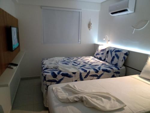 a small room with two beds and a couch at Portoparadise - Beach Class Eco life Residence in Porto De Galinhas