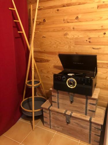 a room with a radio and a wooden wall at Cocon au cœur de Yvoire avec parking gratuit in Yvoire