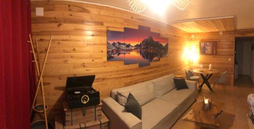 a living room with a couch and a table at Cocon au cœur de Yvoire avec parking gratuit in Yvoire