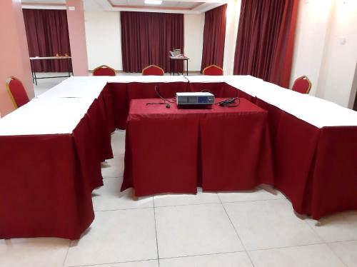 a table with a red table cloth and a radio on it at KILIMANI BREEZE HOTEL in Wote