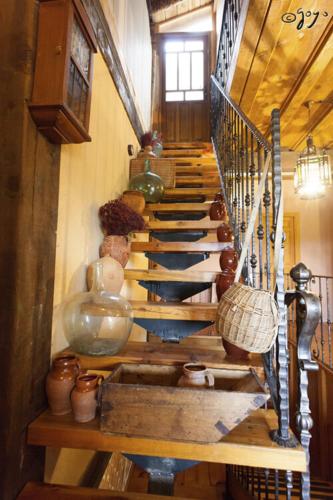a spiral staircase in a room with pots and vases at El Camino Real in Villovela de Pirón