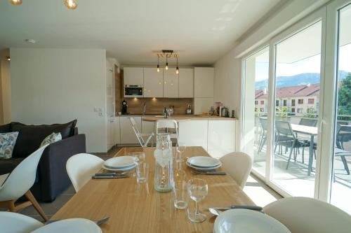 a dining room and kitchen with a table and chairs at La Douce Folie - Apartment for 4 to 5 people in Sevrier in Sévrier