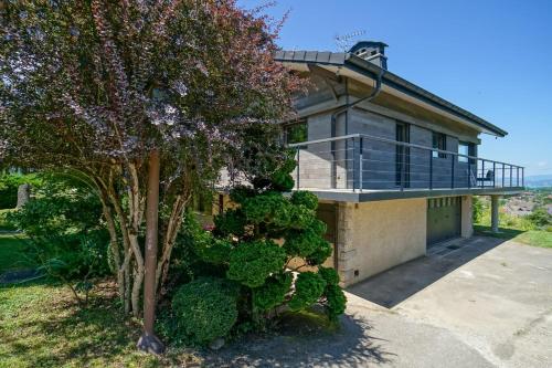 a house with a balcony on top of it at La Petite Montagne in Saint-Jorioz