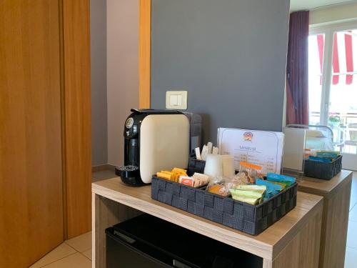 a coffee maker and a box on a counter in a room at The Lighthouse Rooms in Lazise