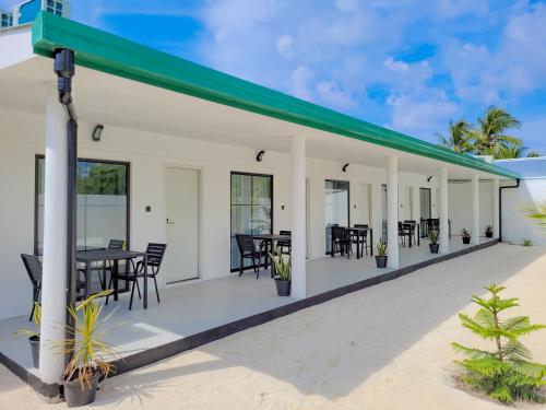 a house on the beach with a green roof at Belvedere Thoddoo in Thoddoo