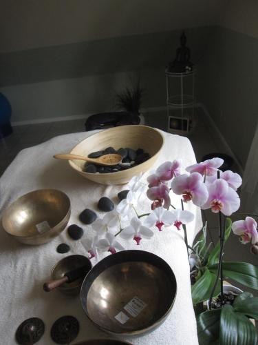 a table with three bowls and flowers on it at Ferienwohnung Wölfle in Friesenheim