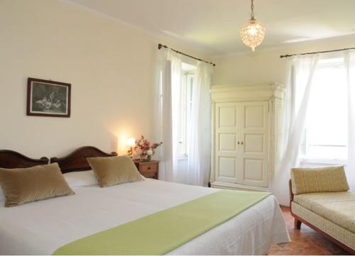 En eller flere senge i et værelse på Guest House Villa Corti