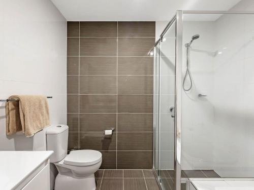 a bathroom with a toilet and a shower at Bluewater Gerringong in Gerringong