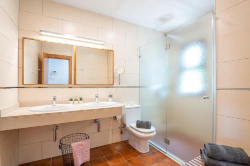 a bathroom with a sink and a toilet and a mirror at Chada Morro Jable in Morro del Jable