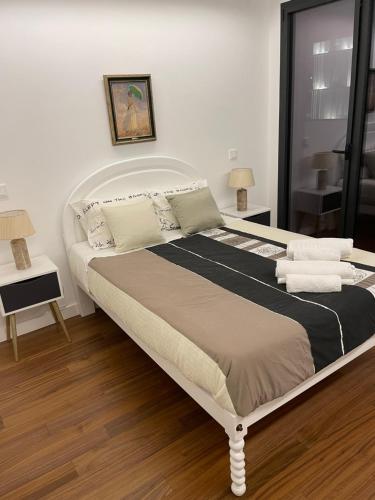 a bedroom with a large bed with pillows at Orpheu Deluxe Apt - Parque das Nações in Lisbon