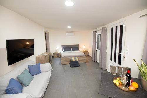 a living room with a couch and a bed at Lithines Villa go green in Dhafnés