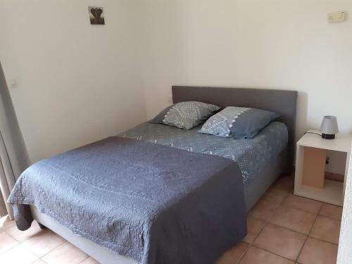 a bed with two pillows on it in a bedroom at Domaine de l'Albatros in Mouans-Sartoux