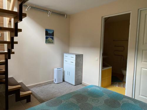 a bedroom with a bed and a dresser and a closet at Kalnas II apartaments in Juodkrantė
