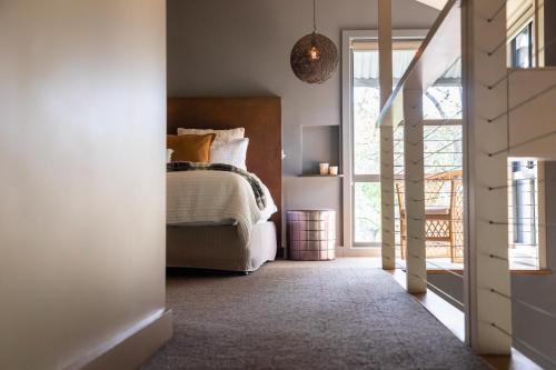 a bedroom with a bed and a large window at The Edge Villa in Mount View