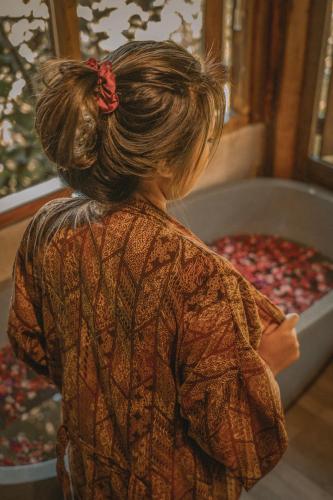 a woman with her hair in a ponytail at Gumi Ayu EcoStay in Munduk