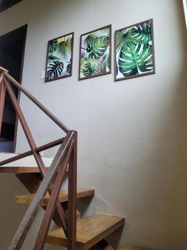 four pictures of plants on a wall with a staircase at Mares de Camburizinho in Camburi