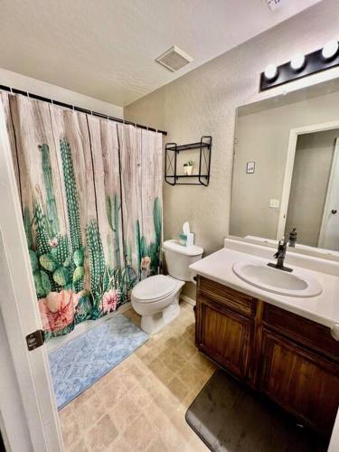 a bathroom with a toilet and a shower curtain at Glendale Pool Heat Pet Friendly in Glendale