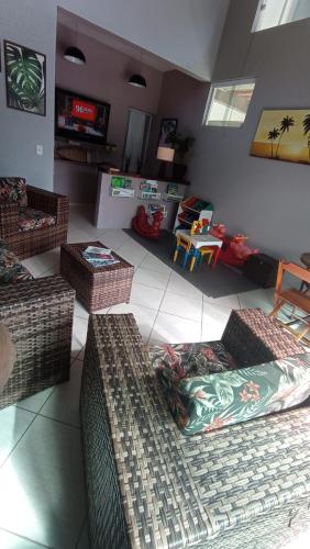 a living room with couches and tables in a room at Mares de Camburizinho in Camburi