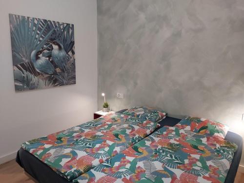 a bed with a colorful comforter in a bedroom at Casa Agua y Sol I in Poris de Abona