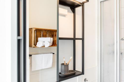 a mirror in a bathroom with towels at Sächsischer Hof in Meißen