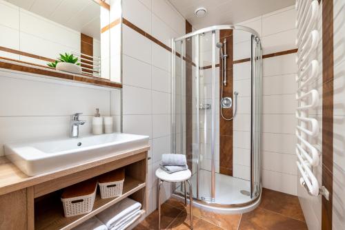 a bathroom with a sink and a shower at Haus Gumpold 2 in Wagrain