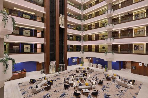 an overhead view of a large lobby with couches and tables at voco Al Khobar by IHG in Al Khobar