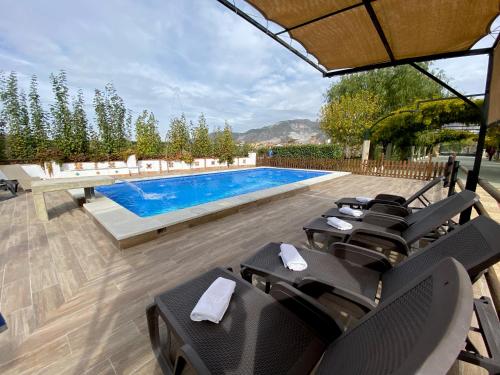 una piscina con tumbonas y una piscina en Villa Elisabeth, en Granada