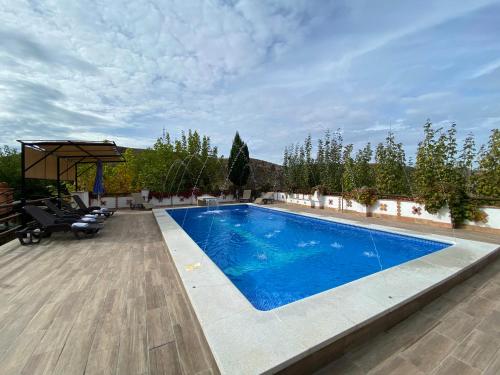 a swimming pool with blue water in a yard at Villa Elisabeth in Granada